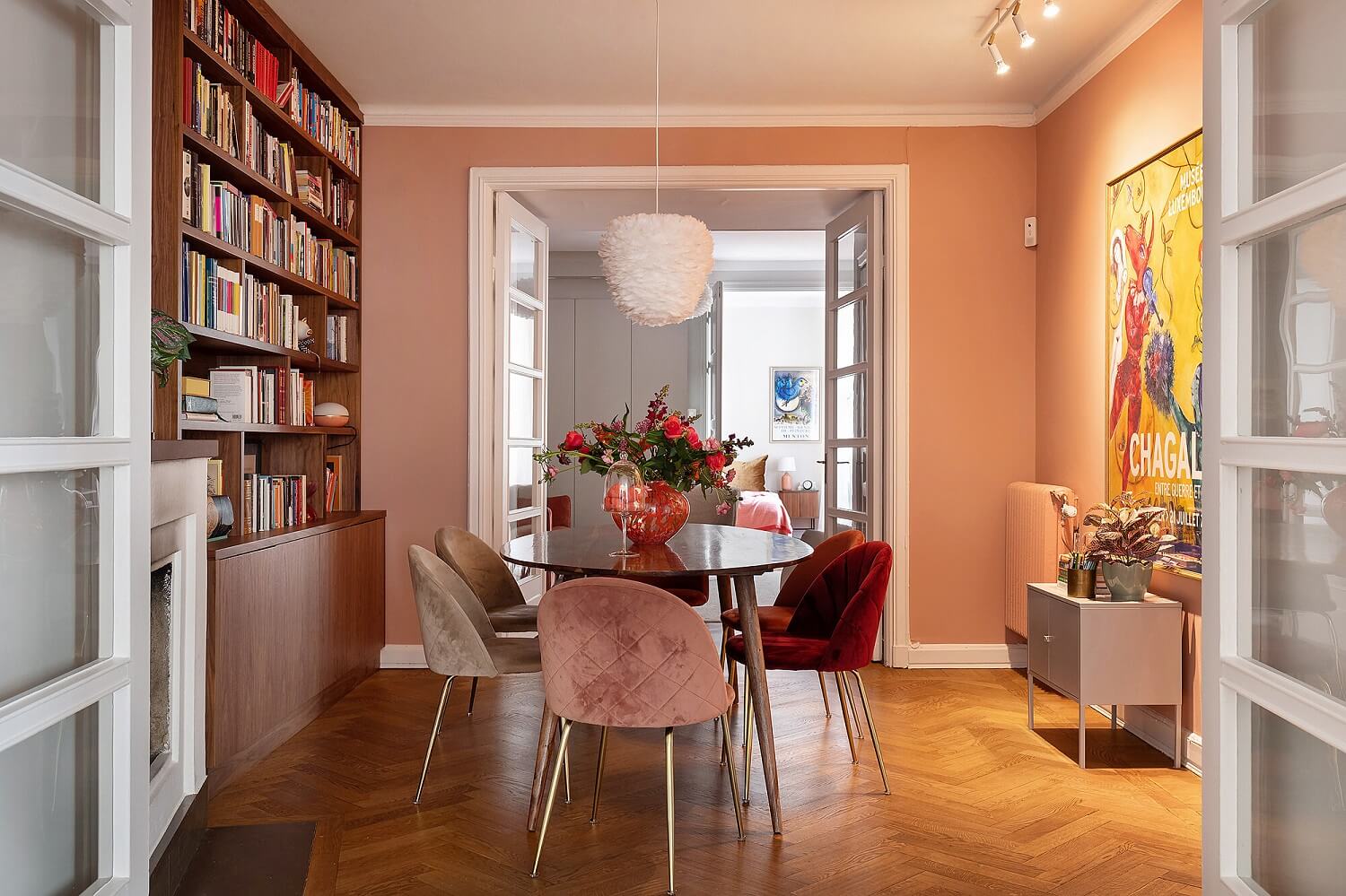 dining-room-pink-walls-bookcase-pink-velvet-chairs-wooden-floors-nordroom