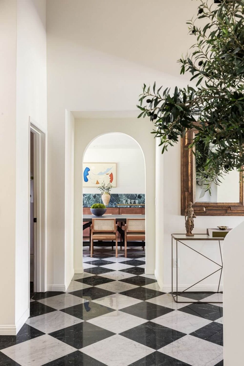 hallway-checkerboard-floor-tiles-arched-doorway-nordroom