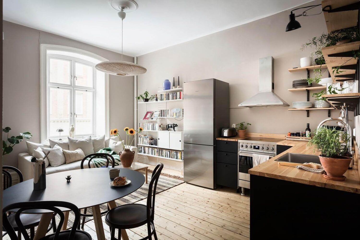 open-plan-living-room-kitchen-black-cabinets-nordroom