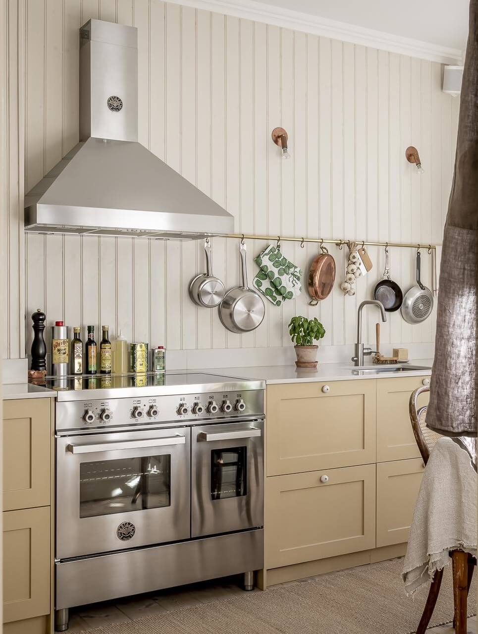 pale-yellow-kitchen-cabinets-wooden-wall-nordroom