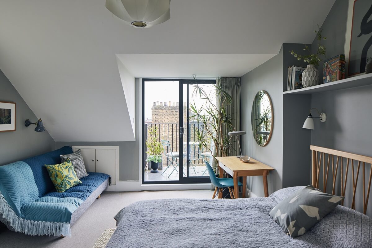 bedroom-slanted-ceiling-balcony-gray-walls-shelf-above-bed-nordroom