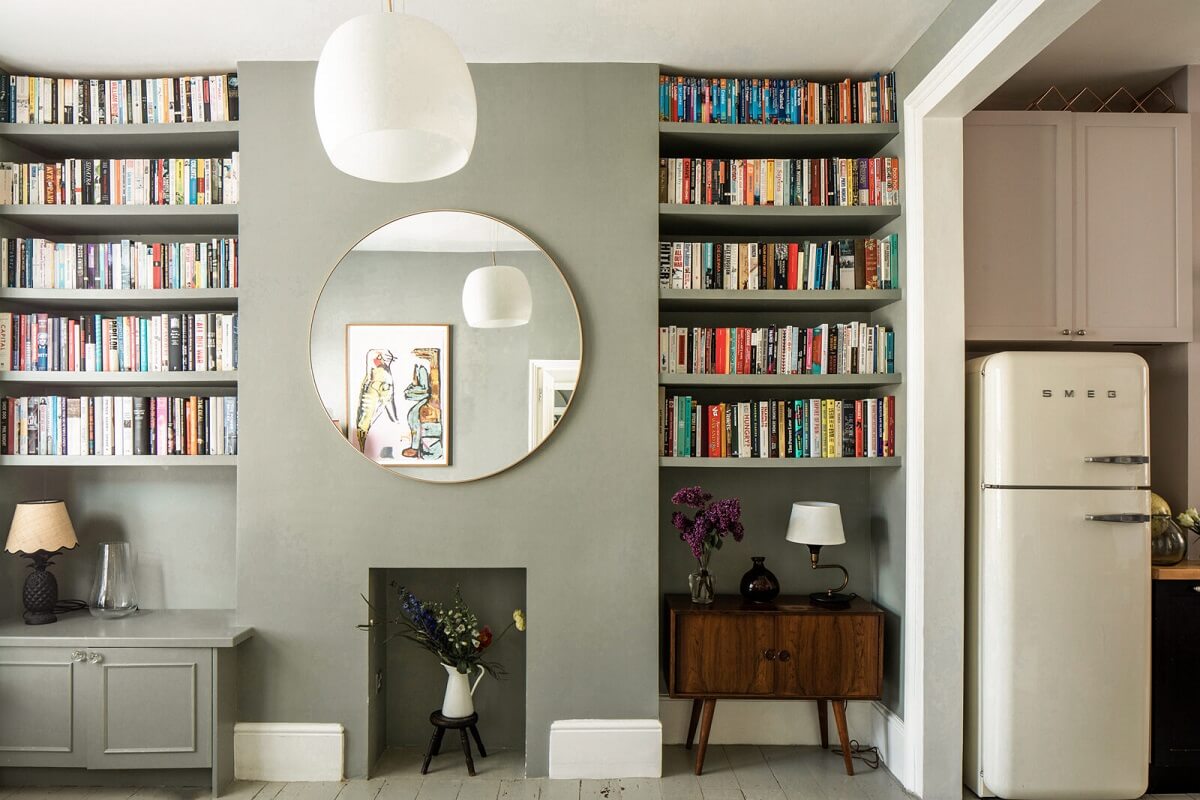 built-in-bookshelves-green-sitting-room-round-mirror-nordroom