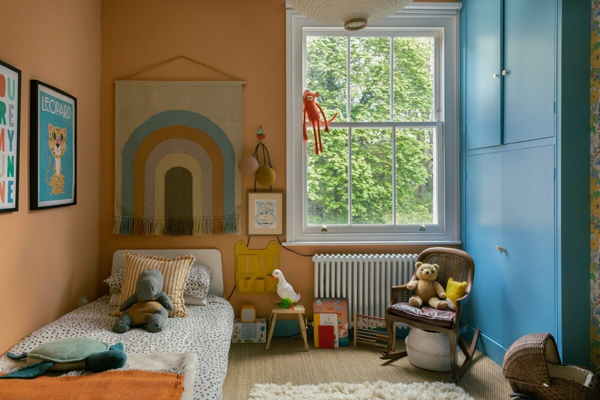 kids-bedroom-salmon-pink-walls-blue-wardrobe-nordroom