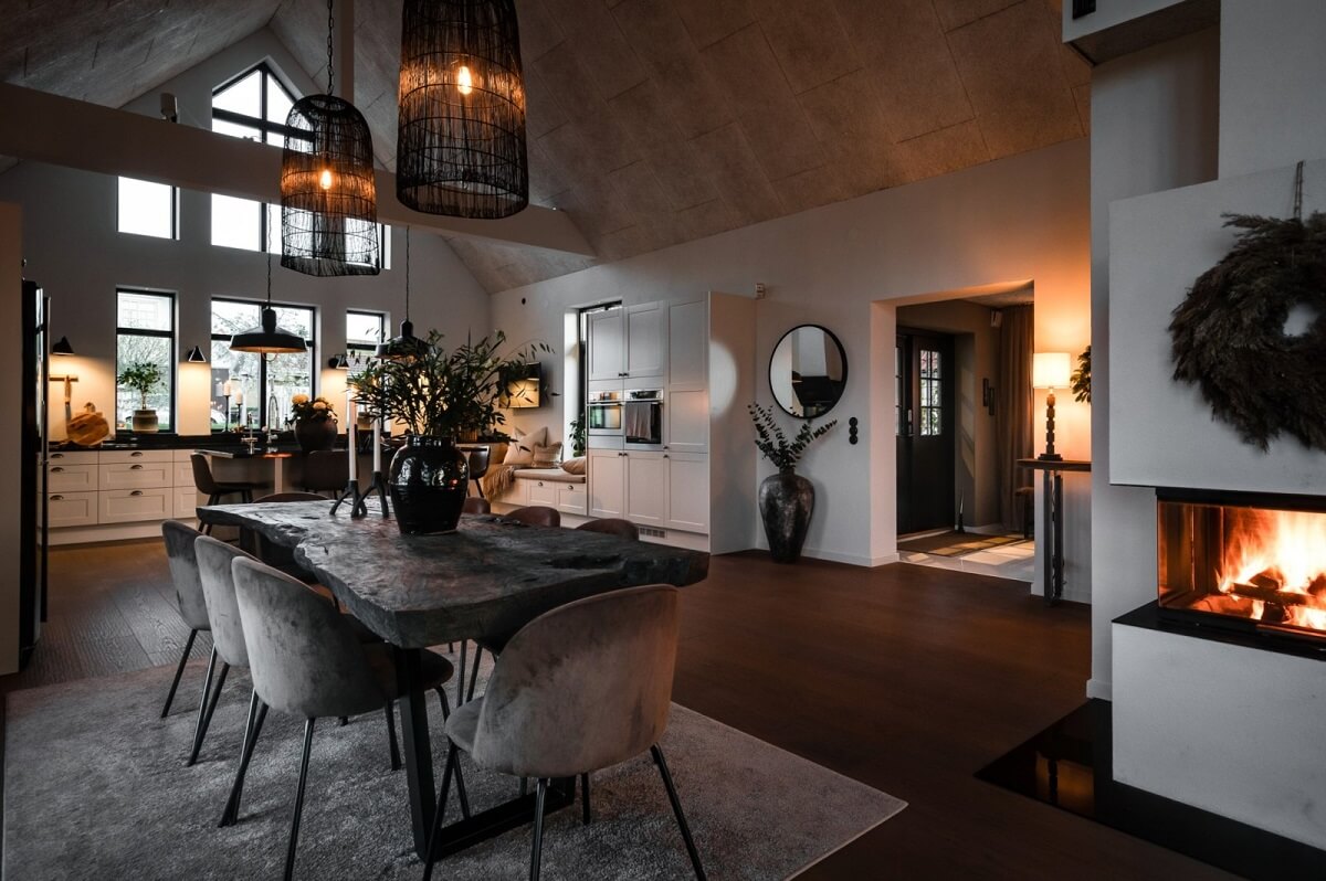 open-plan-scandinavian-living-space-dining-table-high-vaulted-ceiling-at-night-nordroom