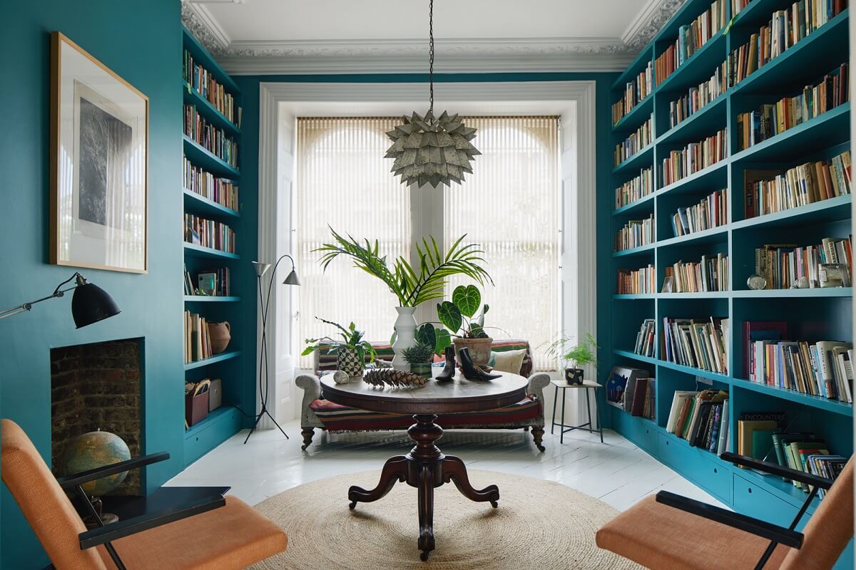 reading-room-deep-teal-bookcases-fireplace-round-antique-table-nordroom
