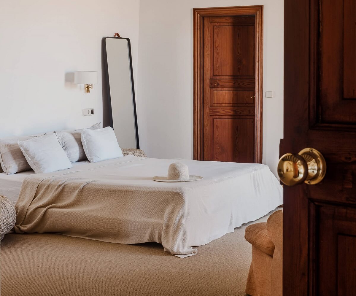 serene-bedroom-beige-carpet-rustic-wooden-doors-nordroom