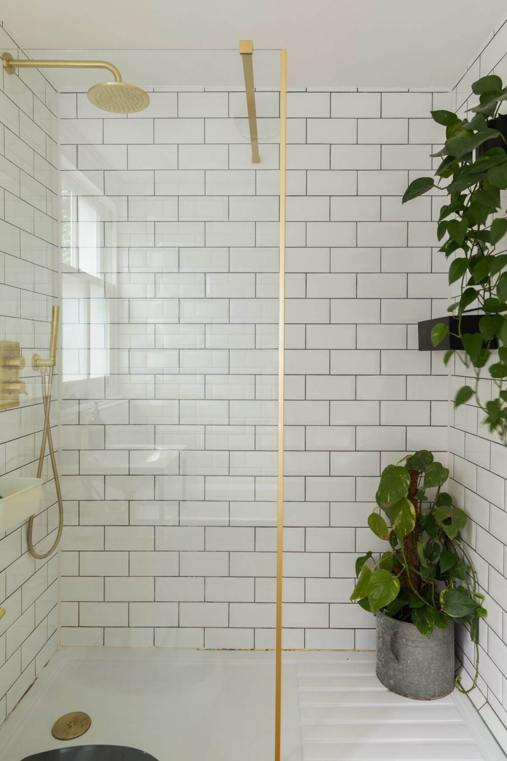 small-bathroom-shower-white-subway-tiles-brass-fixtures-nordroom