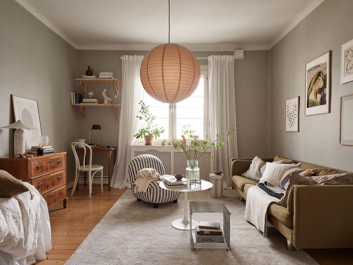 studio-apartment-gray-walls-green-sofa-desk-shelves-nordroom