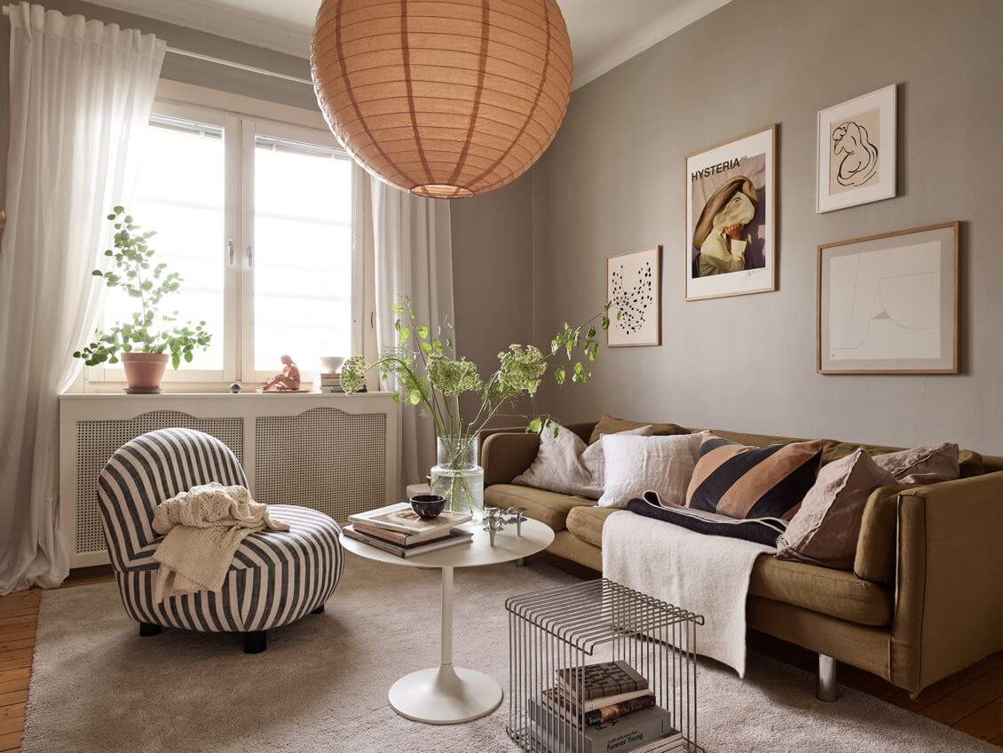 studio-apartment-gray-walls-seating-area-green-sofa-striped-armchair-nordroom
