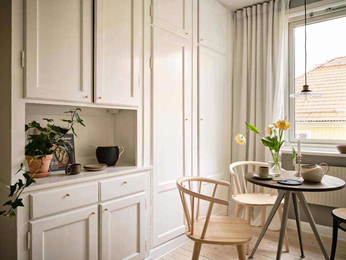 studio-apartment-kitchen-built-in-cabinets-small-round-dining-table-nordroom