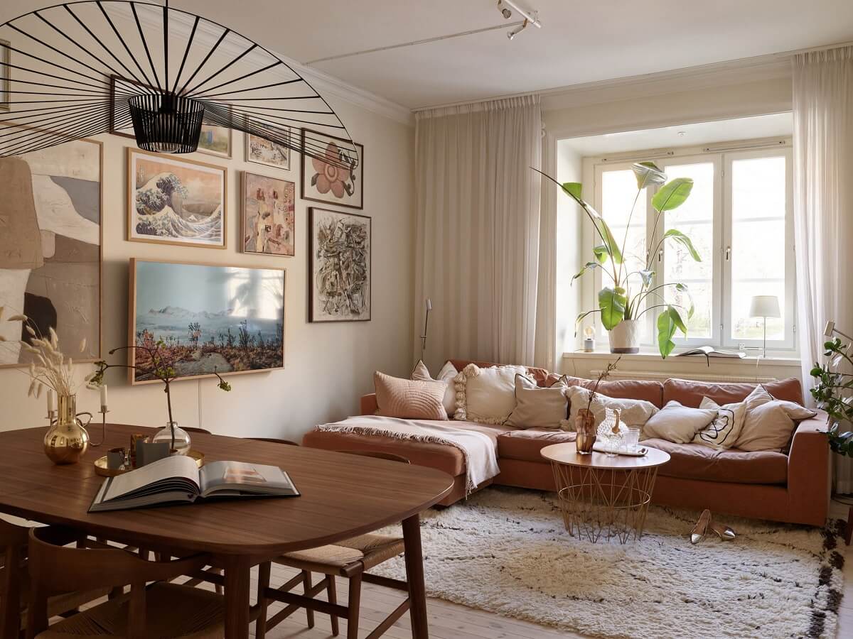 warm-beige-living-room-orange-red-sofa-gallery-wall-nordroom