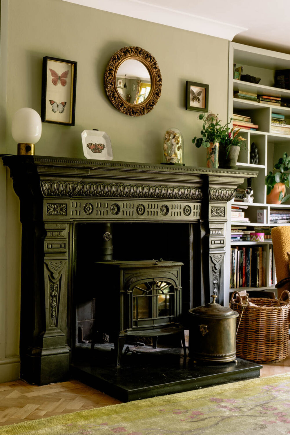 black-carved-fireplace-green-living-room-nordroom