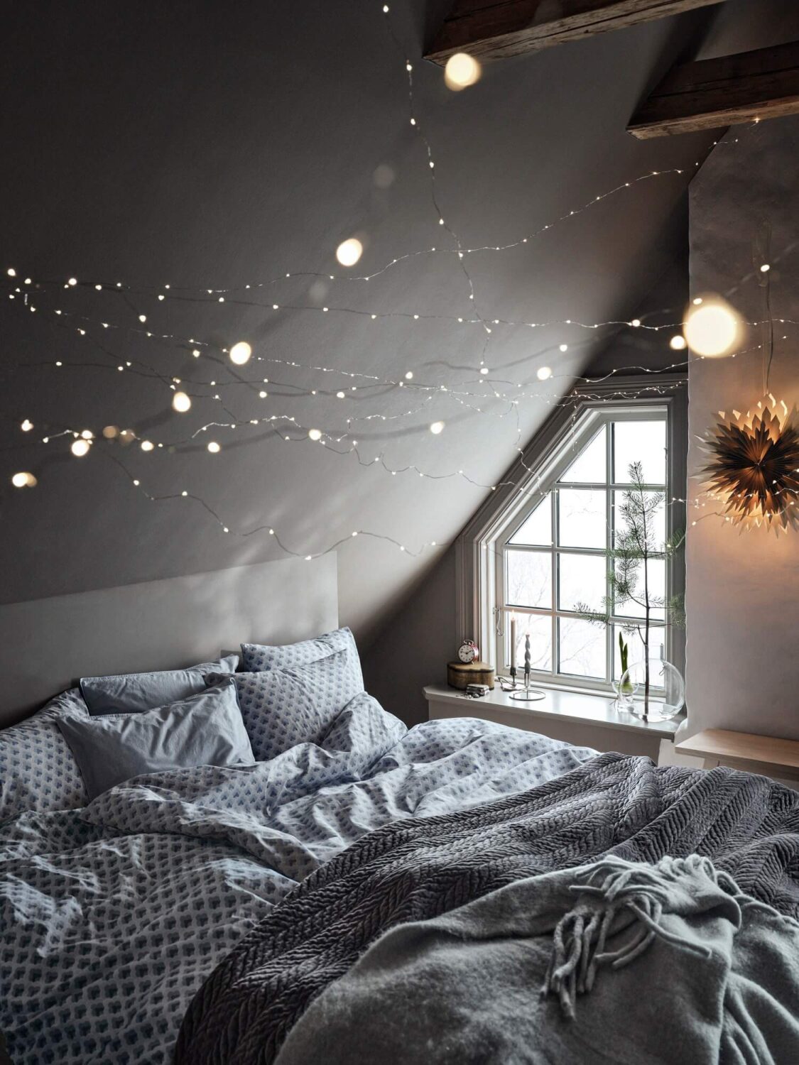 cozy-bedroom-string-lights-slanted-ceiling-nordroom