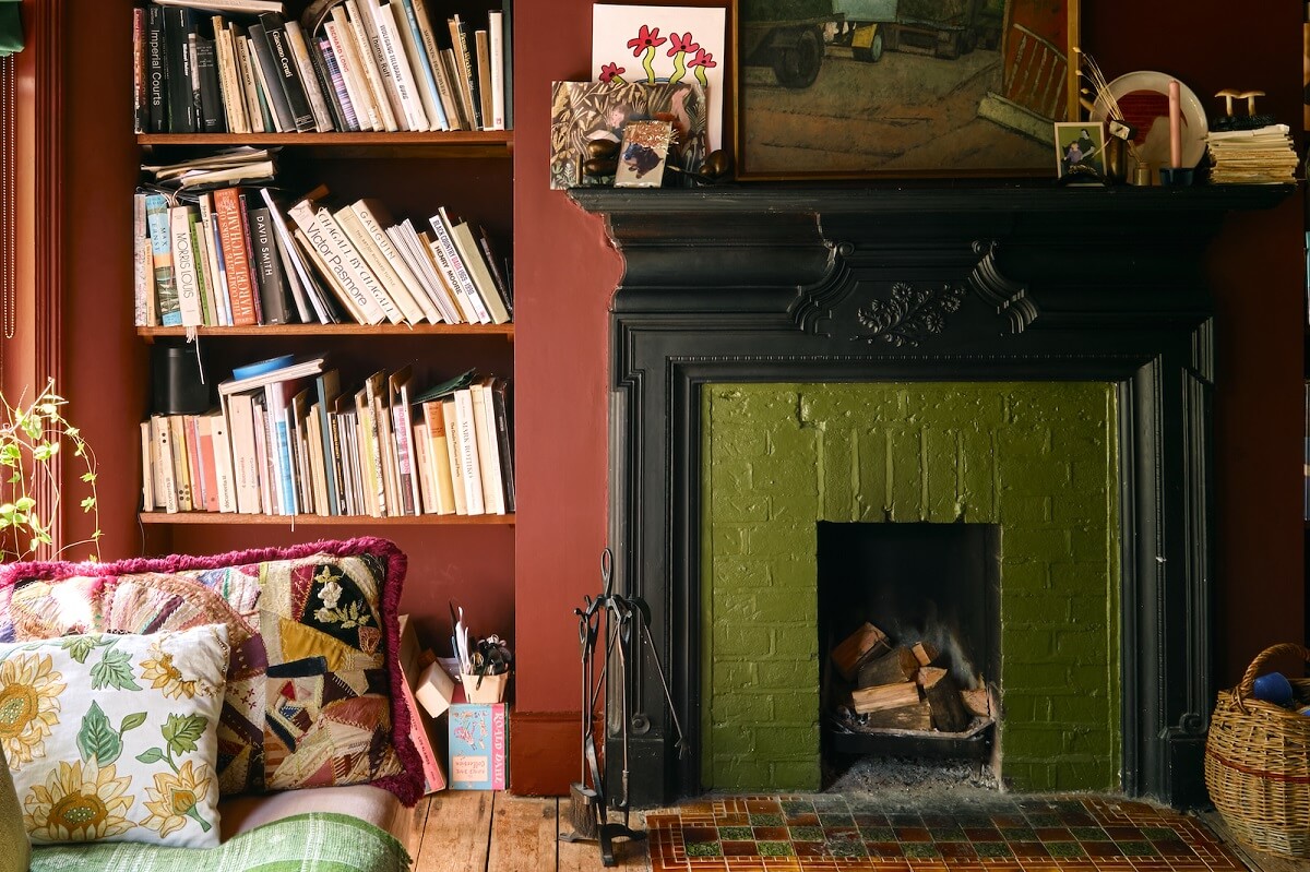 green-painted-brick-fireplace-bookshelves-nordroom