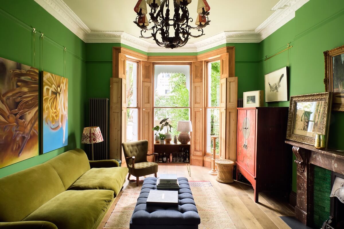 living-room-emerald-green-walls-bay-window-wood-shutters-nordroom