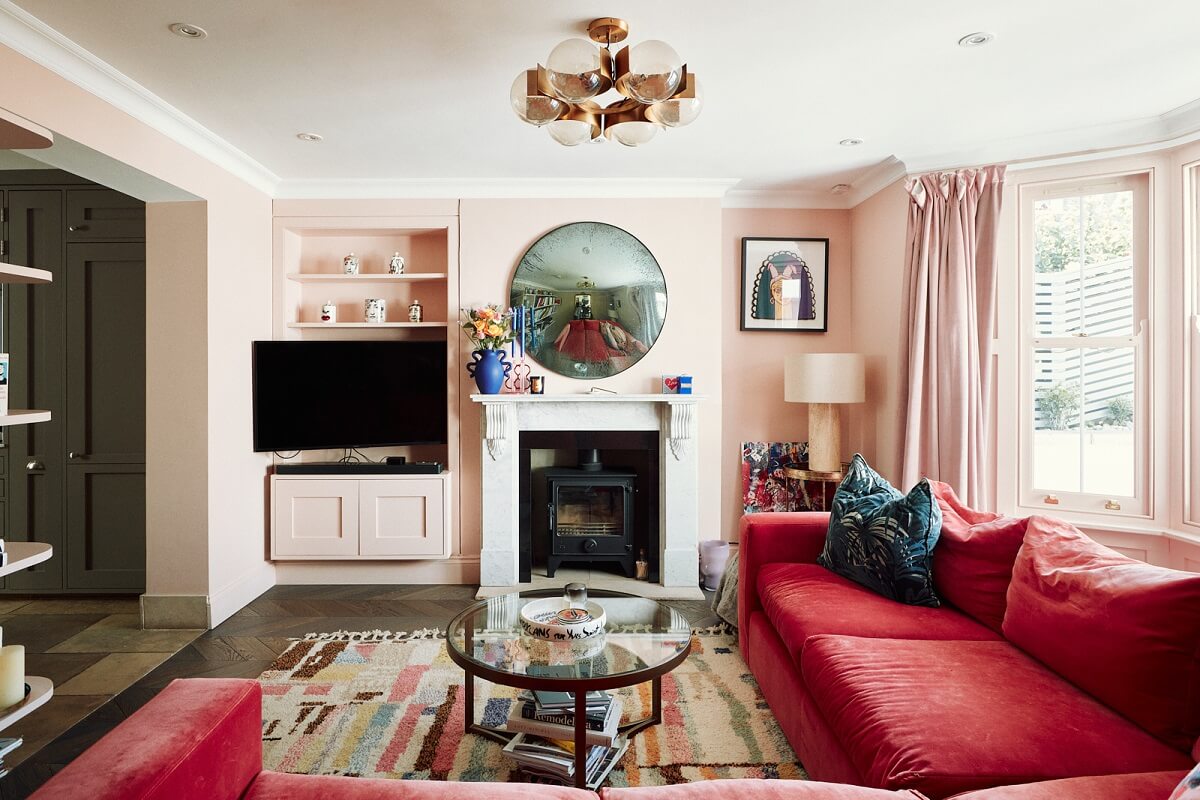 living-room-light-pink-walls-dark-pink-couch-nordroom