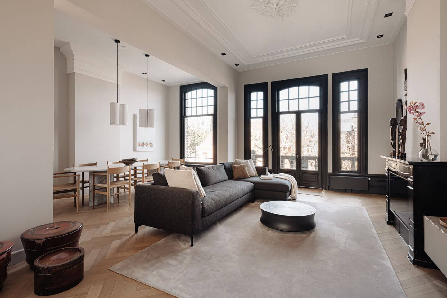 monochrome-living-room-dark-gray-sofa-large-rug-dining-table-nordroom