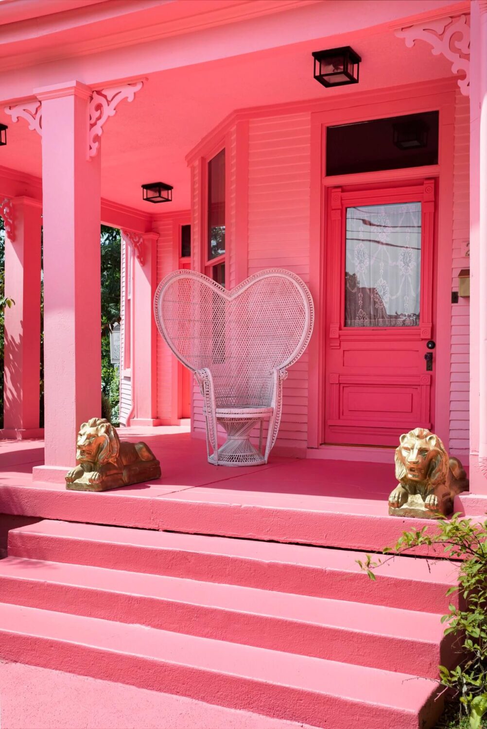 veranda-pink-house-exterior-peacock-chair-barbiecore-nordroom