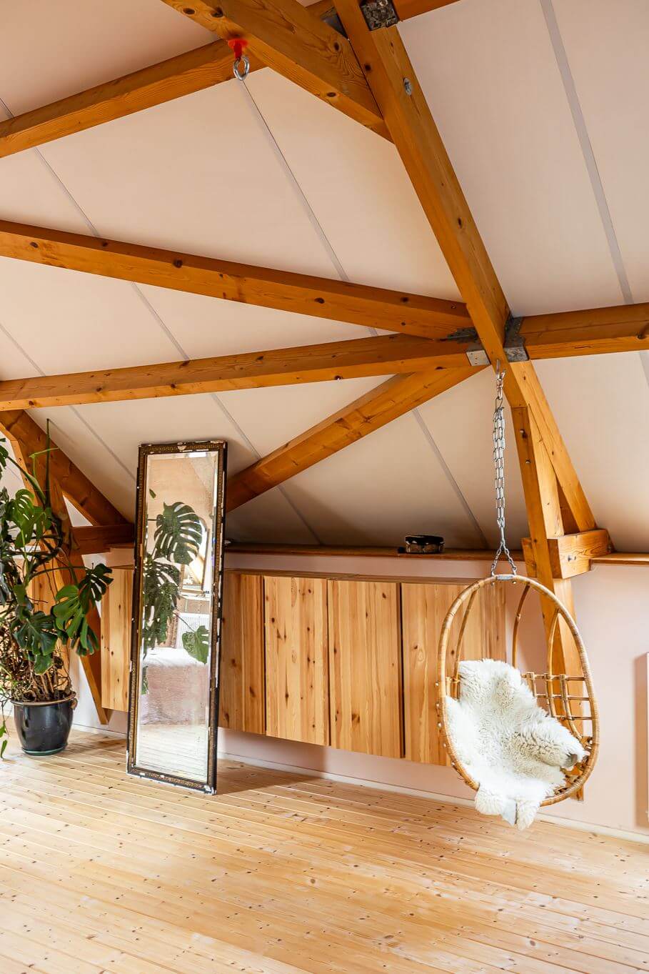 attic-room-wooden-beams-rattan-hanging-chair-nordroom