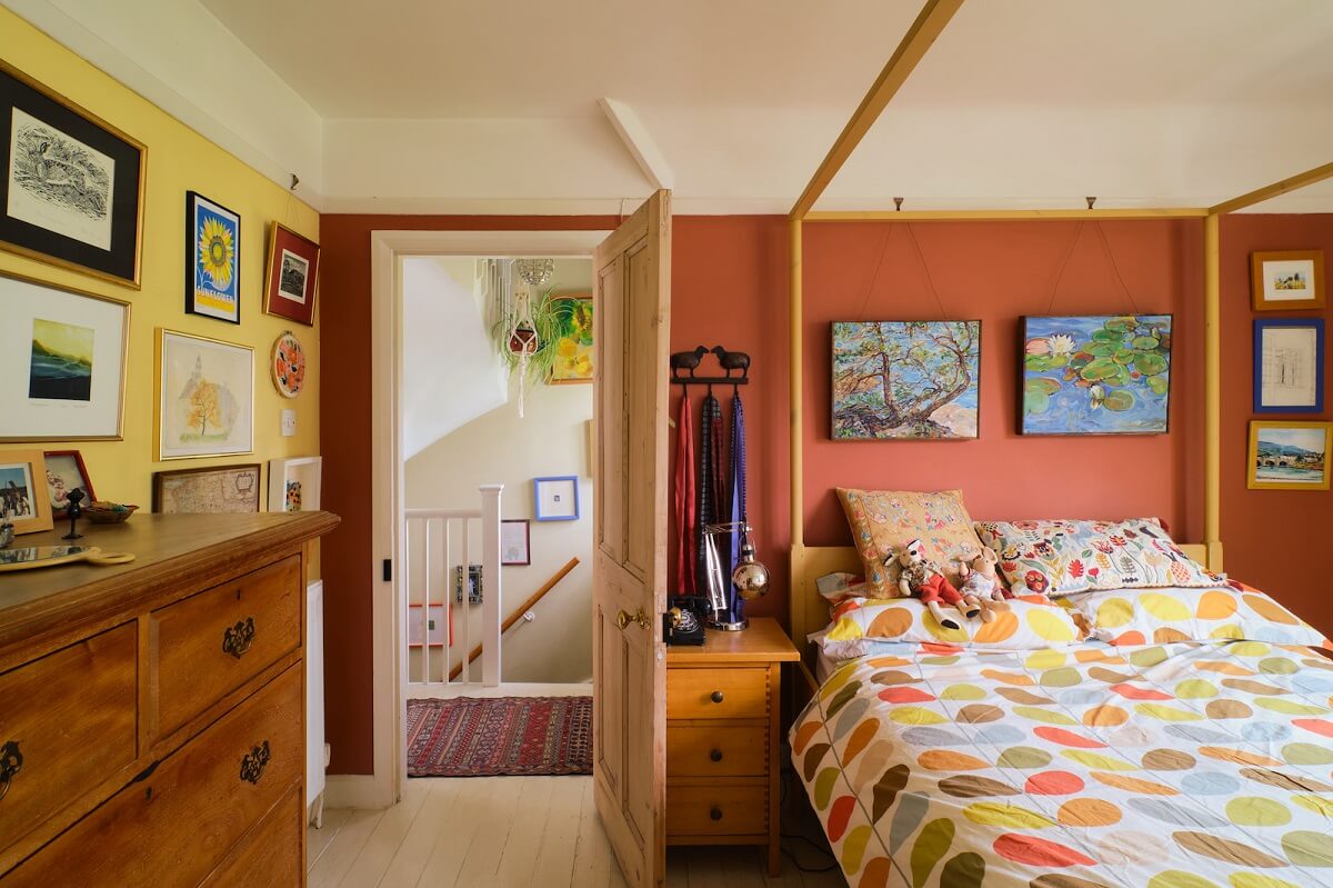 bedroom-canopy-bed-yellow-earthy-orange-walls-nordroom