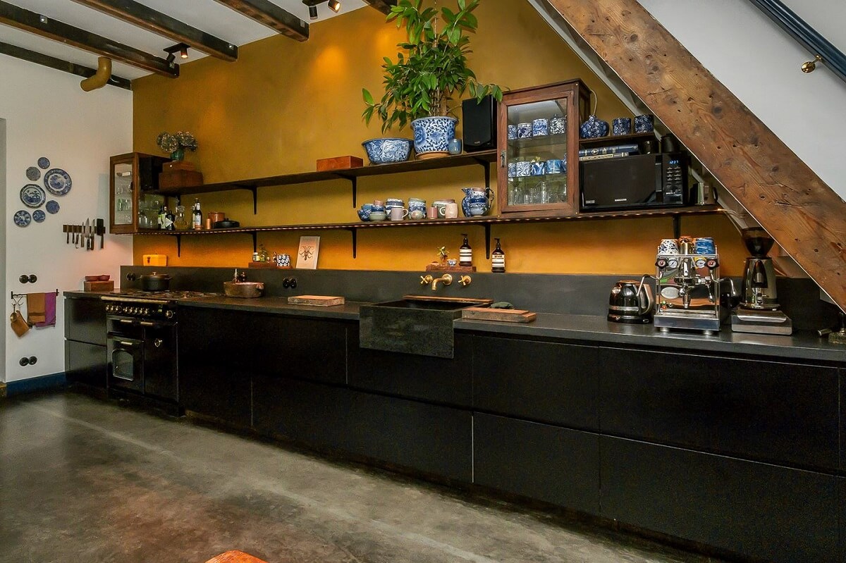 black-kitchen-cabinets-mustard-yellow-walls-exposed-wooden-beams-nordroom