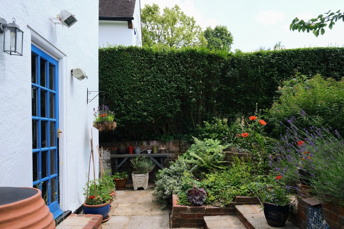 cottage-garden-white-exterior-blue-painted-door-nordroom