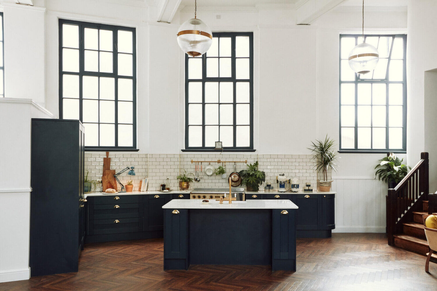 kitchen-high-ceiling-large-windows-dark-blue-cabinets-island-nordroom