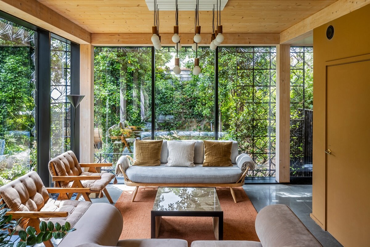 living-room-mustard-yellow-accent-wall-floor-to-ceiling-windows-nordroom