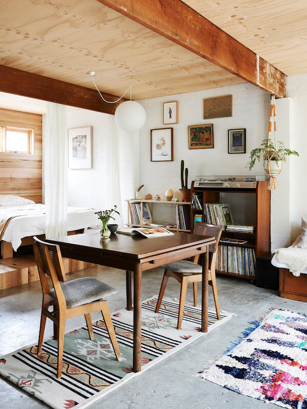 studio-apartment-raised-wooden-platform-bed-area-curtain-nordroom