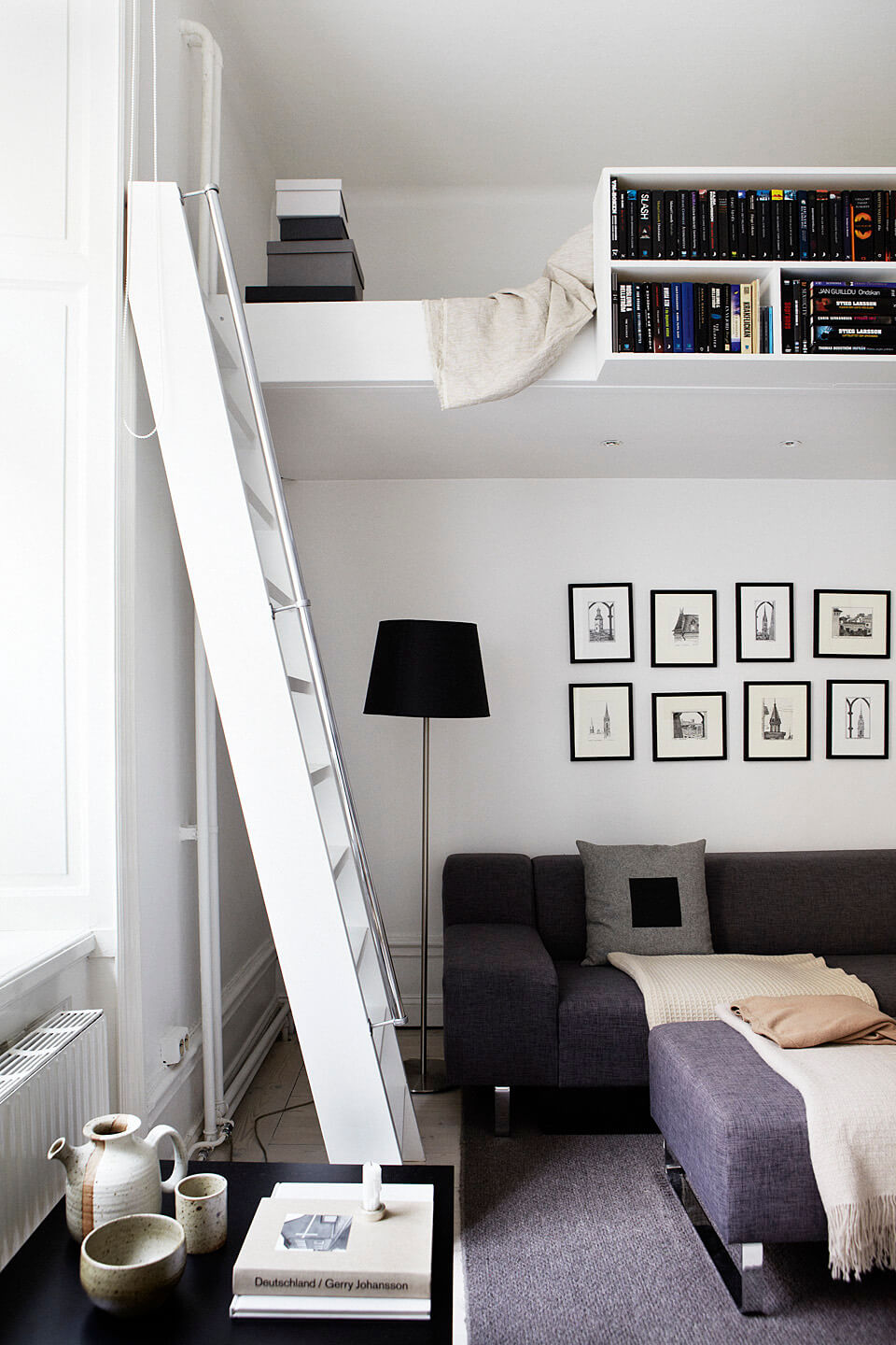 studio apartment with loft bed and bookshelves nordroom