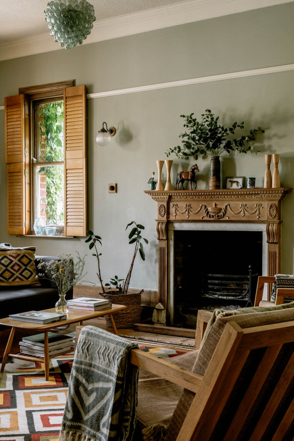 warm-living-room-bohemian-textures-carved-wooden-fireplace-nordroom