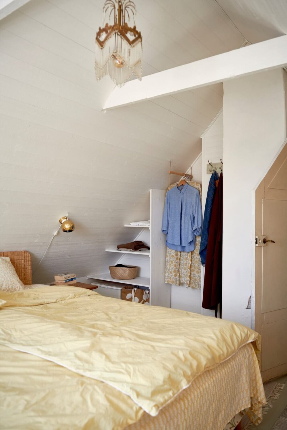 white-attic-bedroom-open-wardrobe-yellow-bedding-nordroom