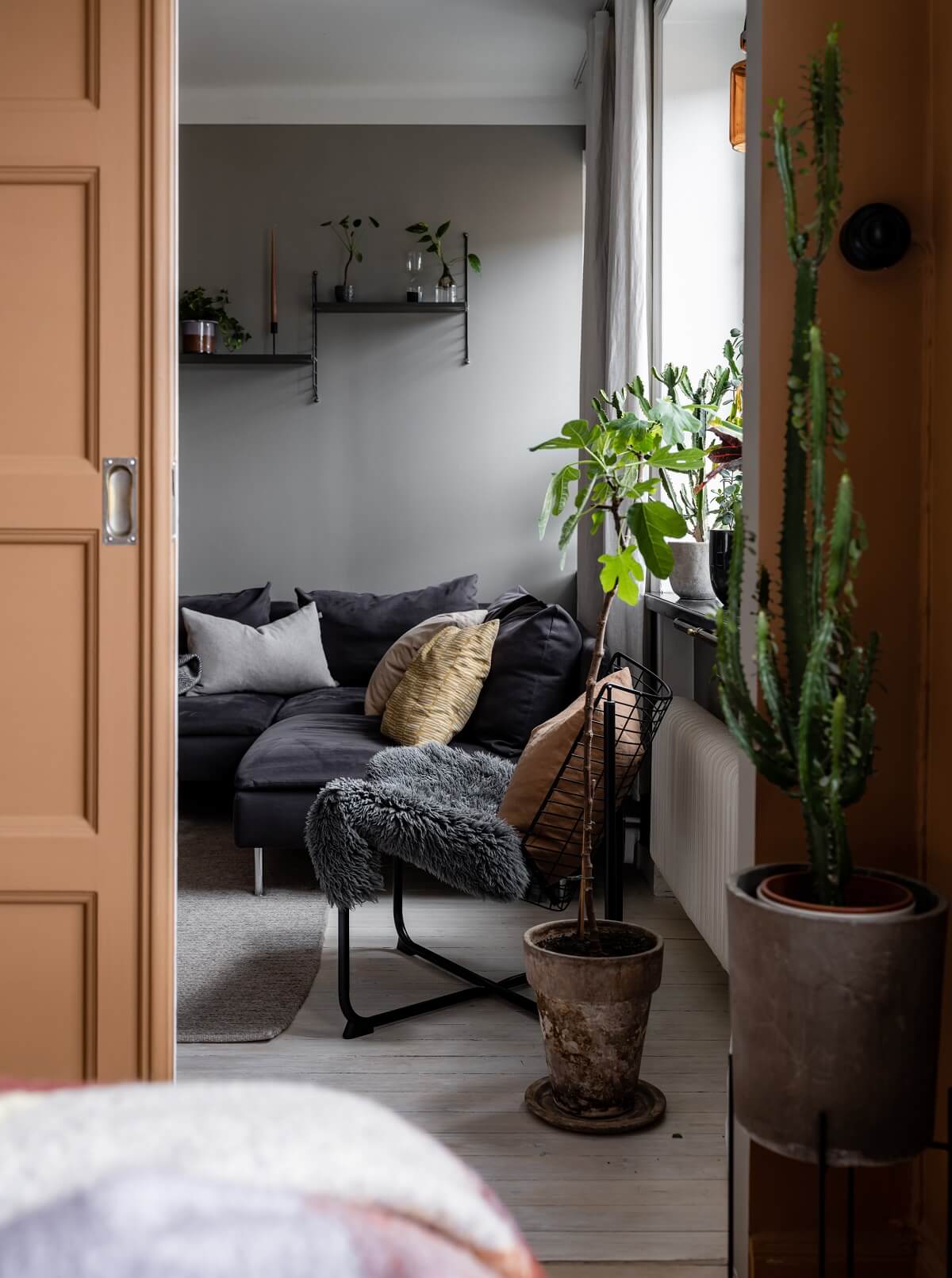 A Gray Nordic Apartment with a Terracotta Bedroom