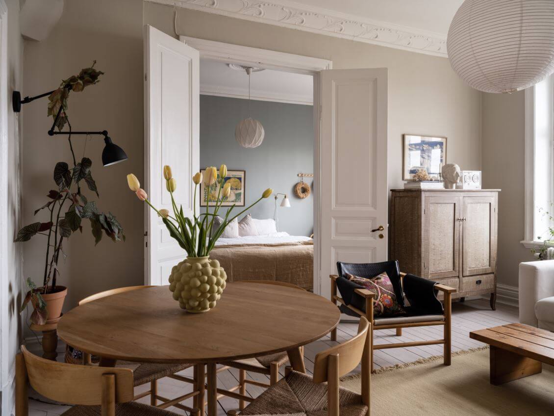 living-room-beige-walls-round-wooden-dining-table-nordroom