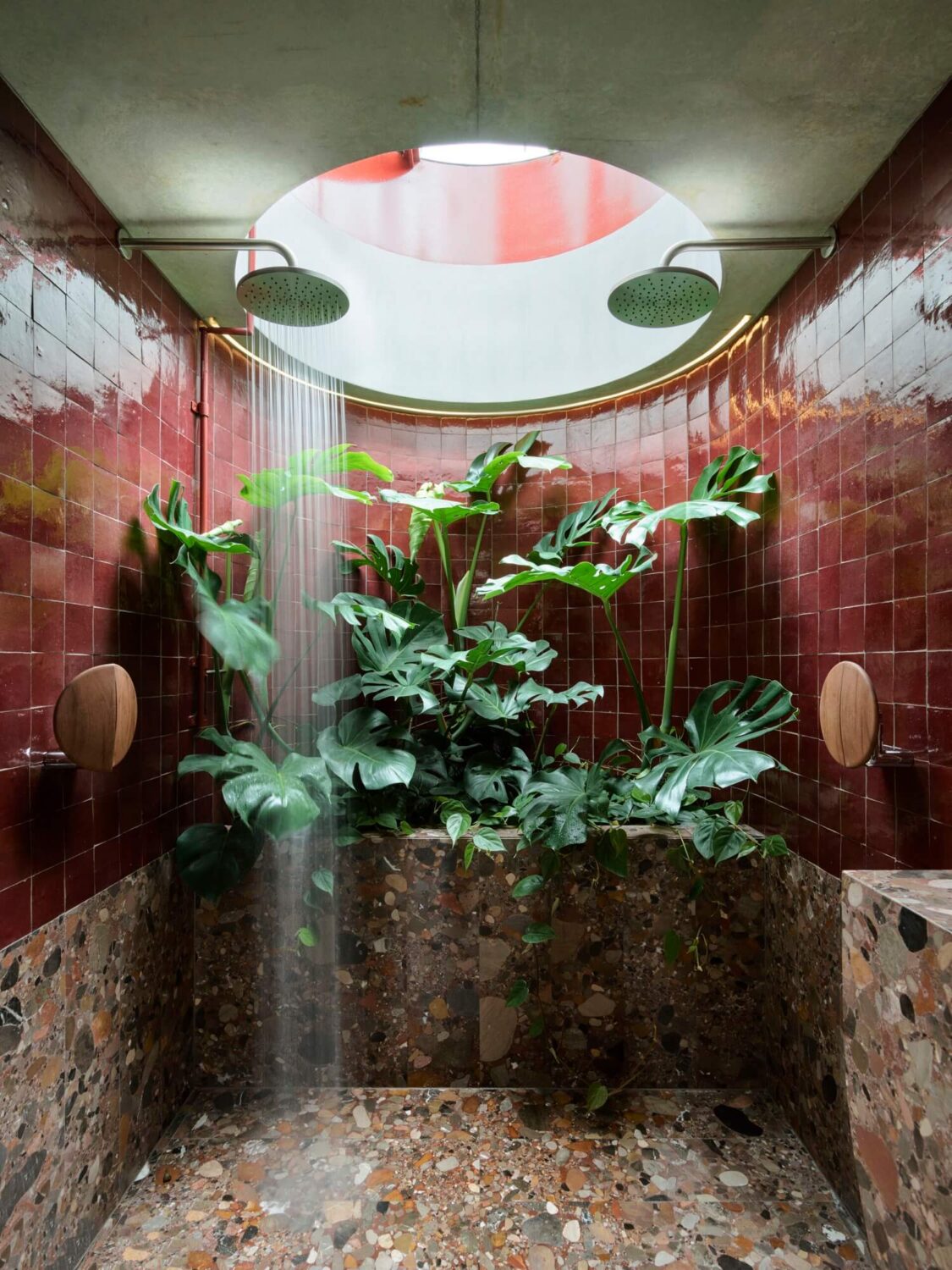 round-shower-with-plants-deep-red-tiles-nordroom