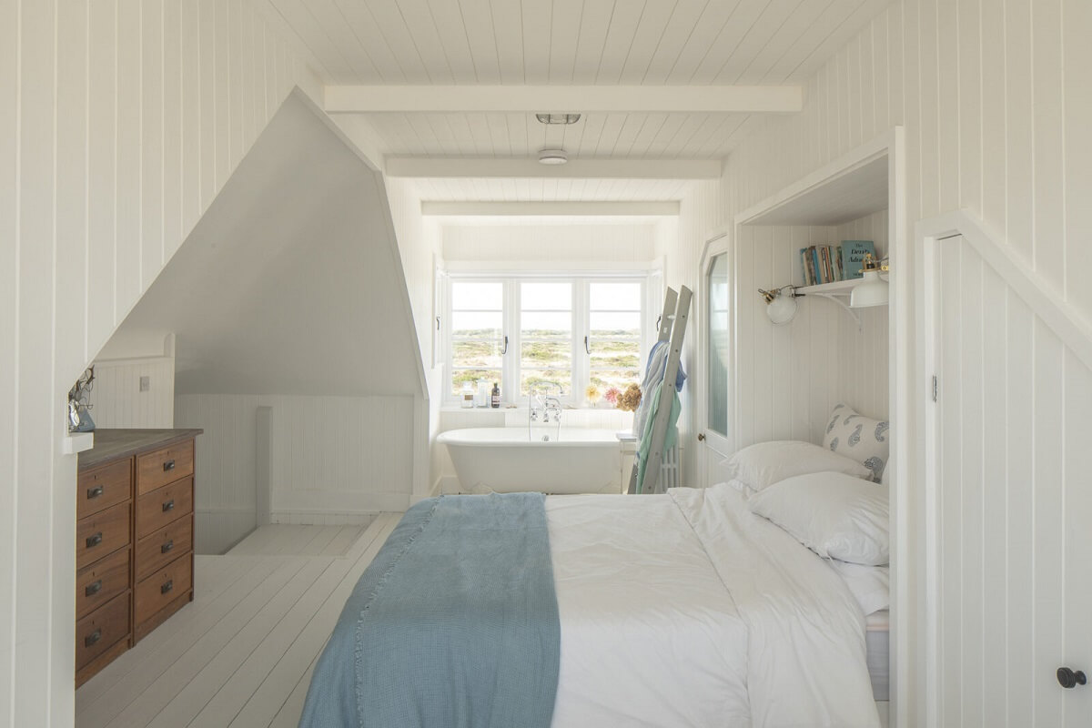 coastal-bedroom-slanted-ceiling-light-blue-throw