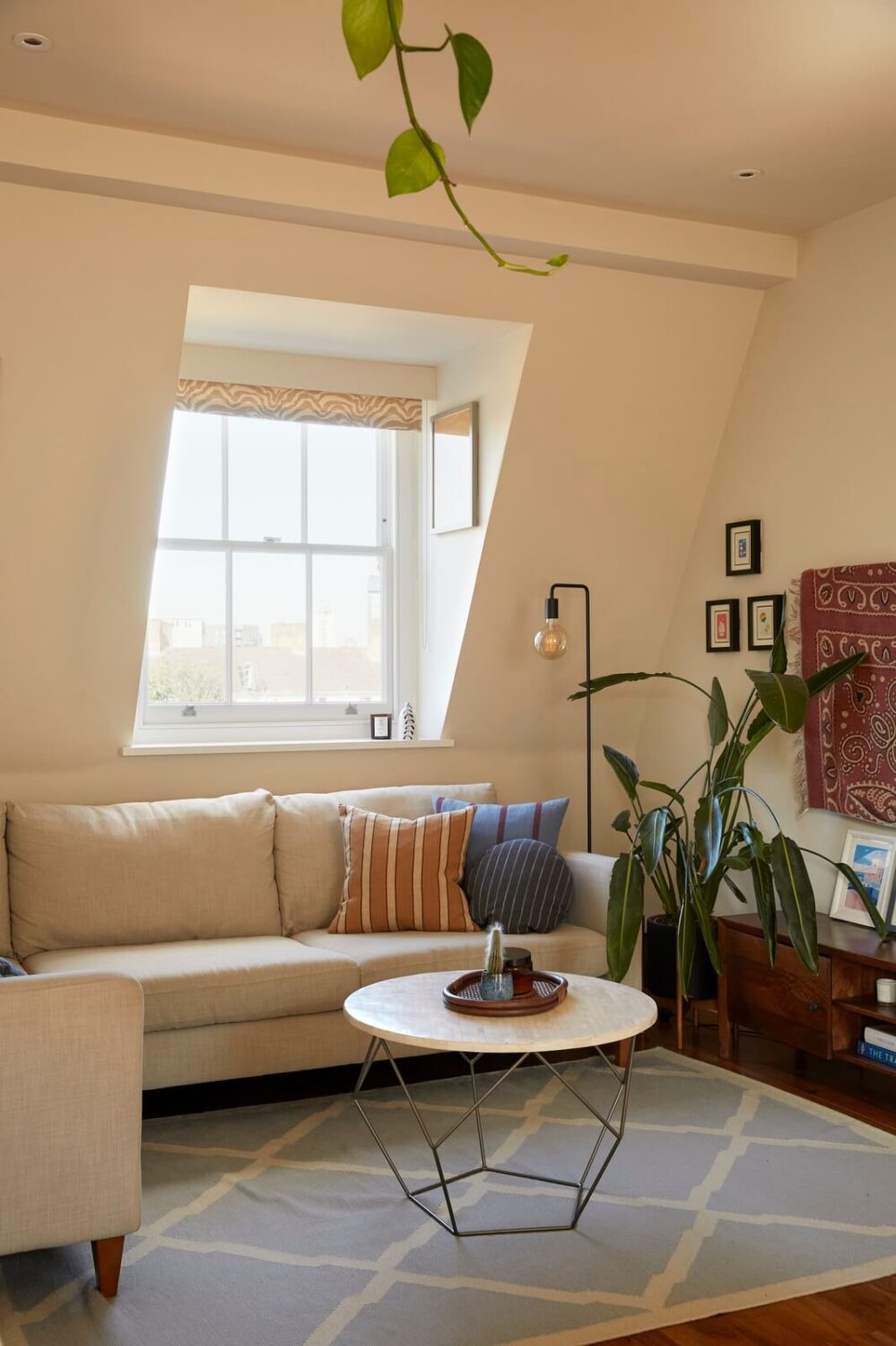 corner-sofa-living-room-slanted-ceiling-light-blue-rug-nordroom