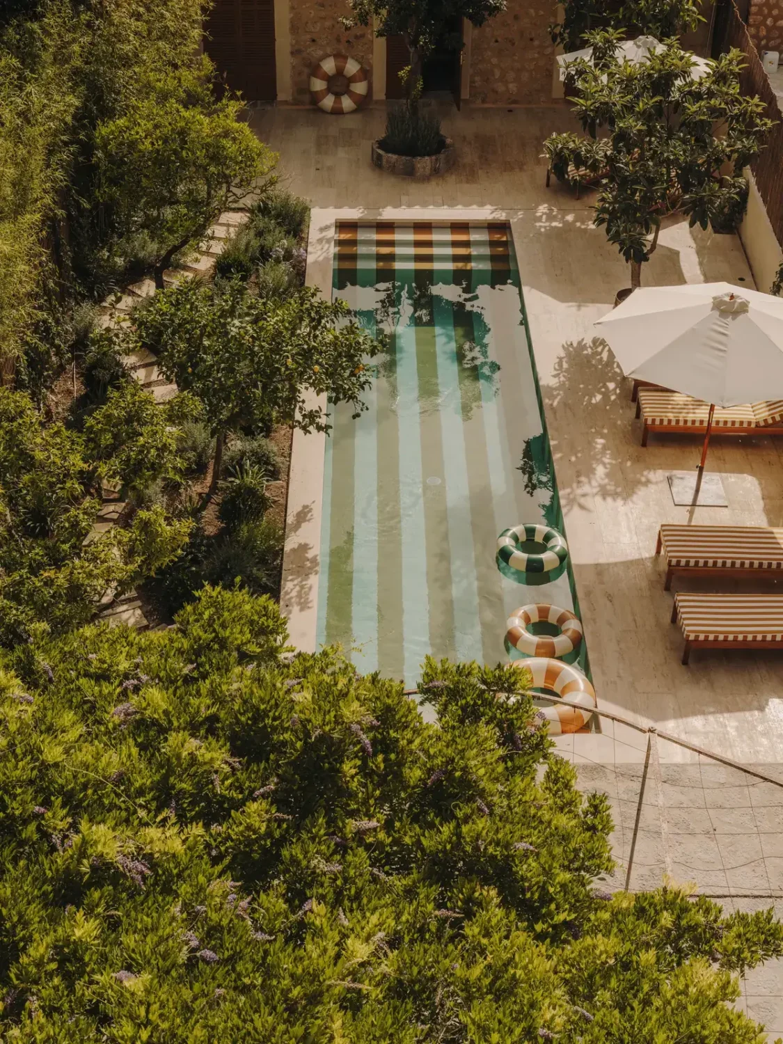 garden-from-above-with-yellow-white-striped-swimming-pool-nordroom