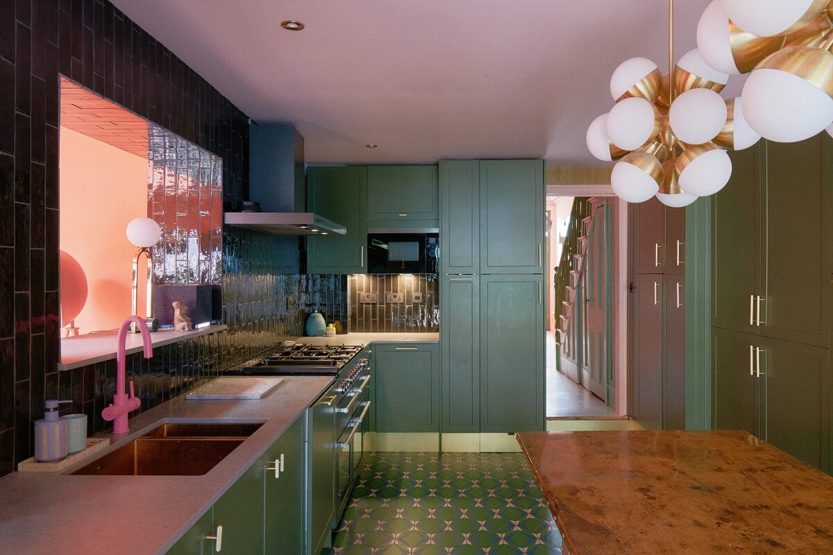 green-kitchen-cabinets-and-tiles-pink-faucet-nordroom