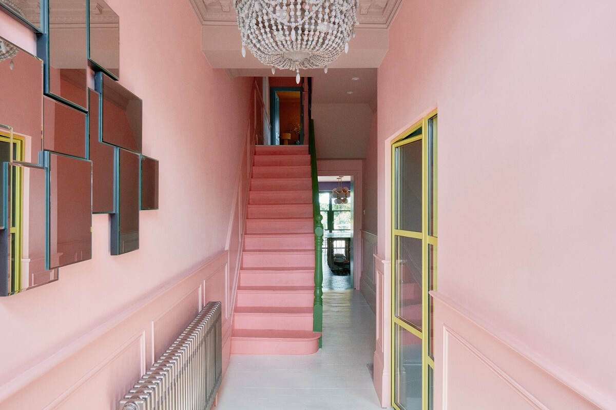 hallway-mirror-pink-walls-darker-pink-stairs-nordroom