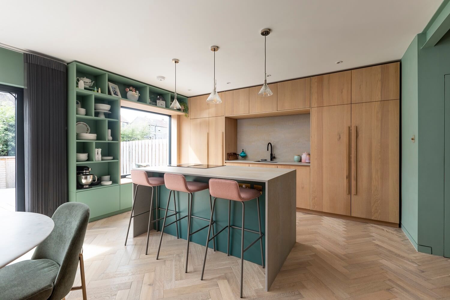 kitchen-oak-cabinets-island-pink-bar-stools-green-open-cabinets-agora-nordroom