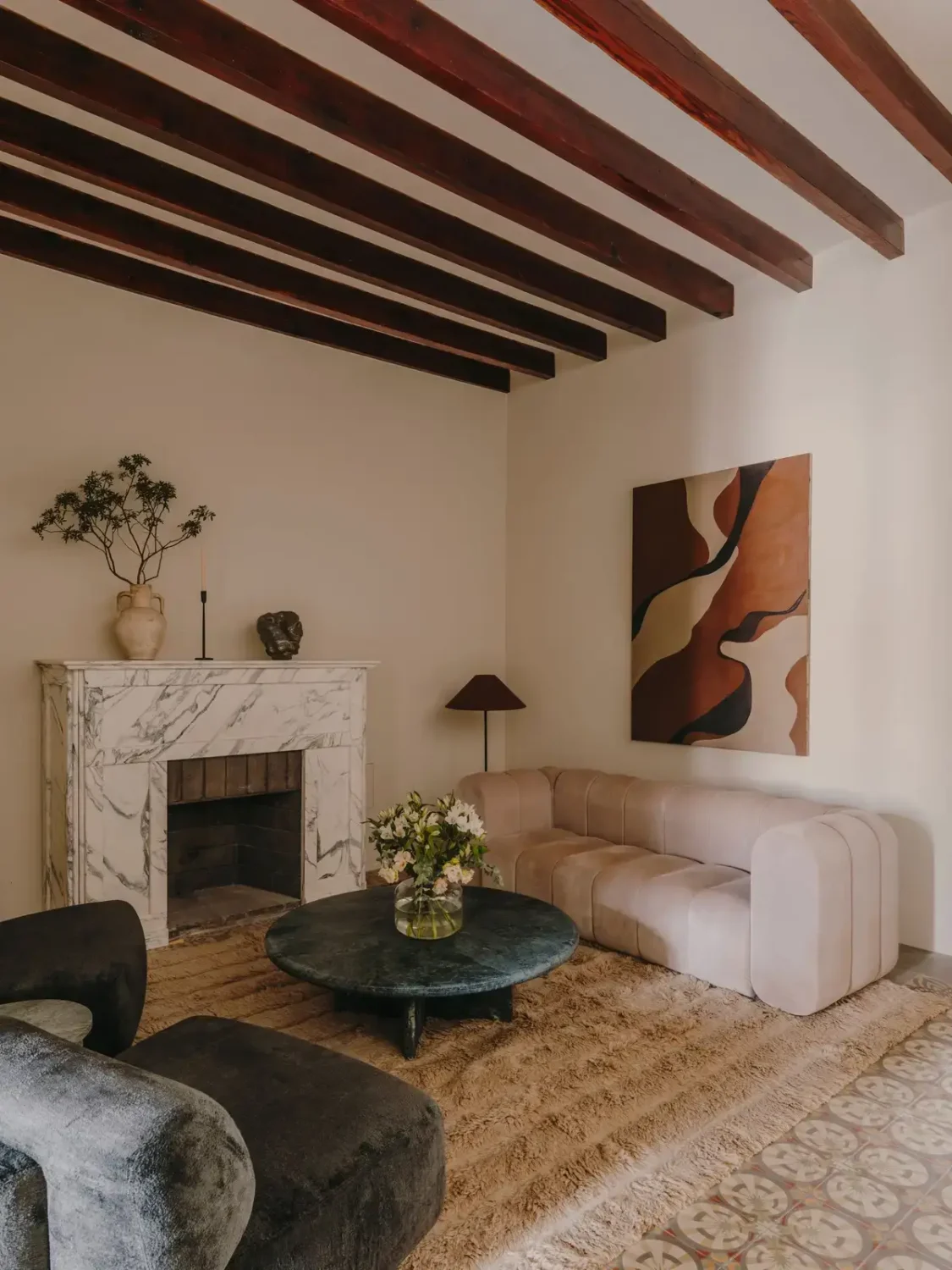 living-room-with-exposed-beams-marble-fireplace-nordroom