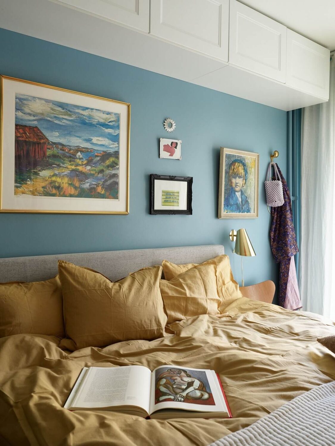 vibrant-blue-bedroom-yellow-bedding-cabinets-over-bed-nordroom