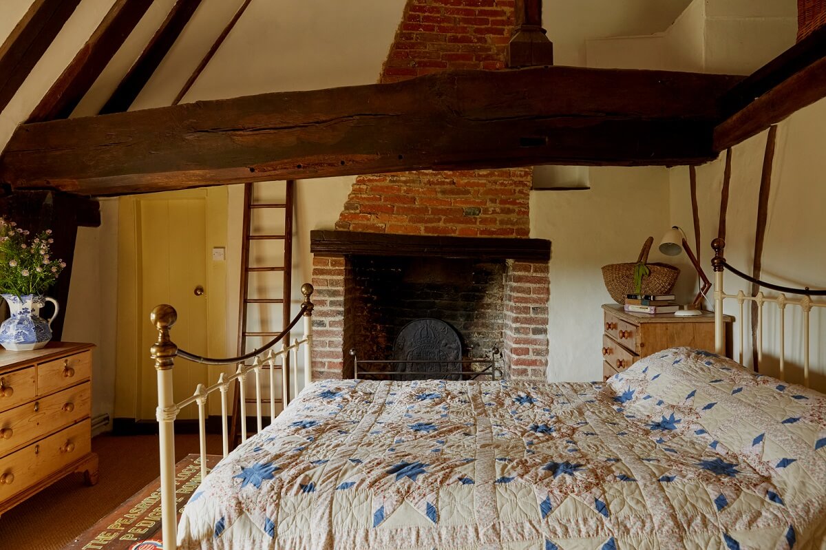 bedroom exposed beams brick fireplace