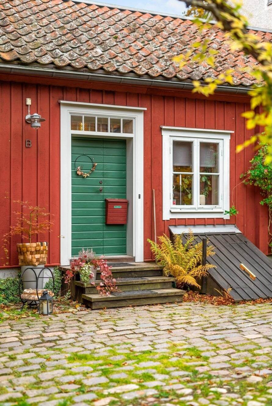green door entry red wooden house