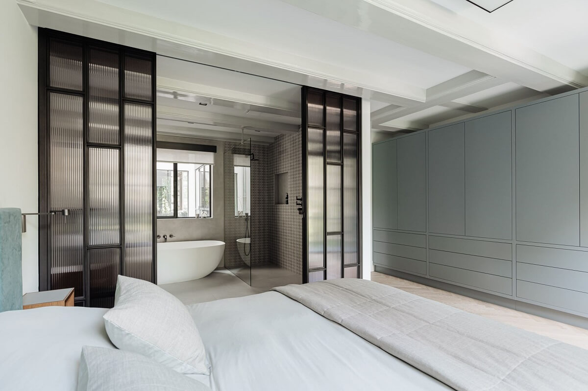 bedroom en suite bathroom steel ribbed glass doors built in wardrobes