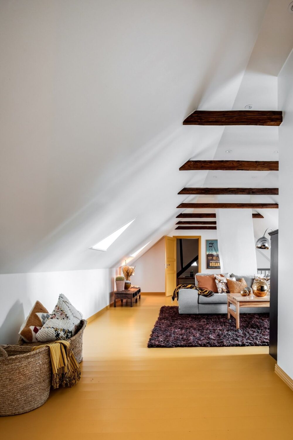 living-room-pitched-ceiling-wooden-beams-yellow-floorboards-nordroom