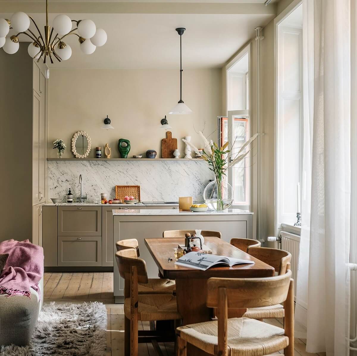 scandinavian living space with wooden dining table and open kitchen