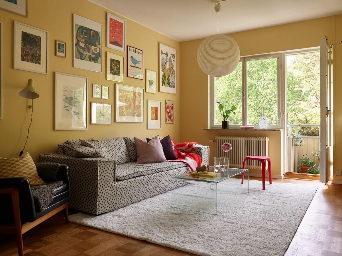 Soft Yellow Walls in a Swedish Apartment 1 yellow-walls-gallery-wall-living-room-large-rug-nordroom