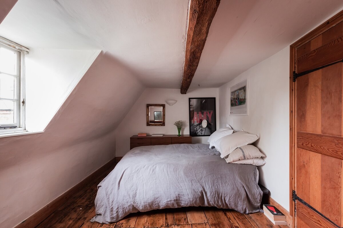 attic bedroom wooden floorboards exposed beam